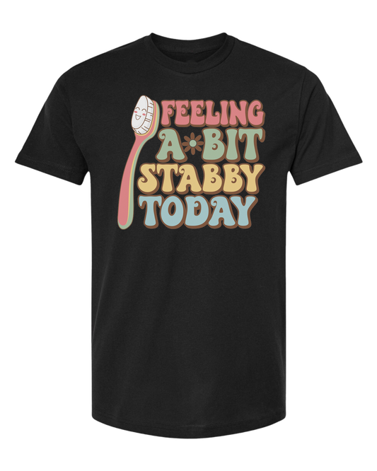 Groovy font "Feeling a bit Stabby" with large toothbrush graphic Classic unisex crewneck tee Short sleeve crew neck