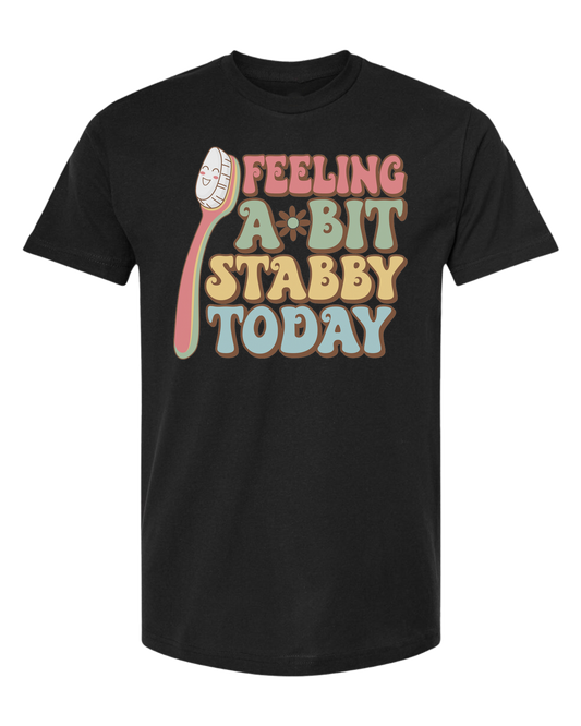 Groovy font "Feeling a bit Stabby" with large toothbrush graphic Unisex crew-neck  graphic tee Black