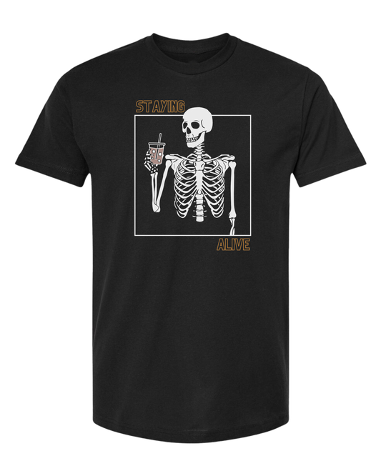 "Staying Alive" skeleton holding a coffee cup Unisex crew-neck  graphic tee Black
